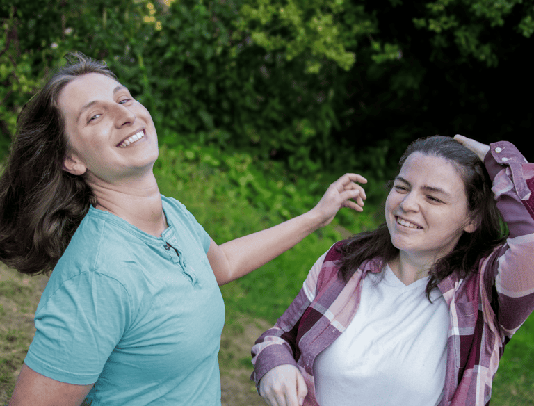 Big Gay Energy host smiling and having fun with their hair
