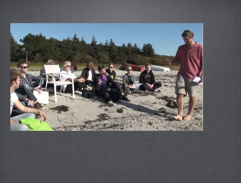 a group of people sitting around a beach