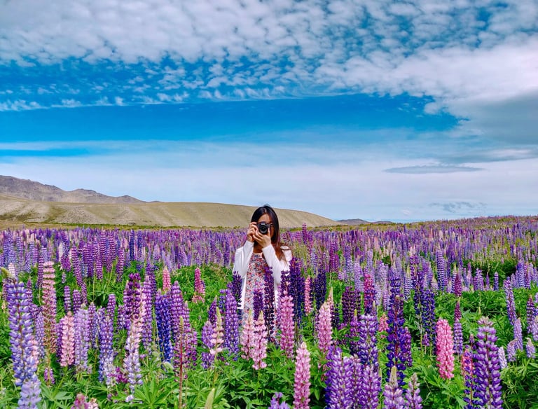 a woman standing in a field of flowers