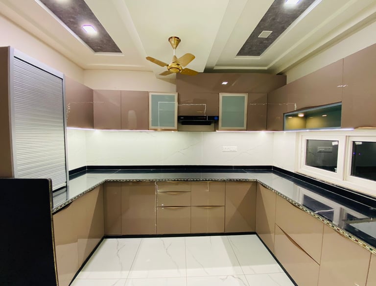 Modern modular kitchen design with wooden cabinets and marble countertop jaipur