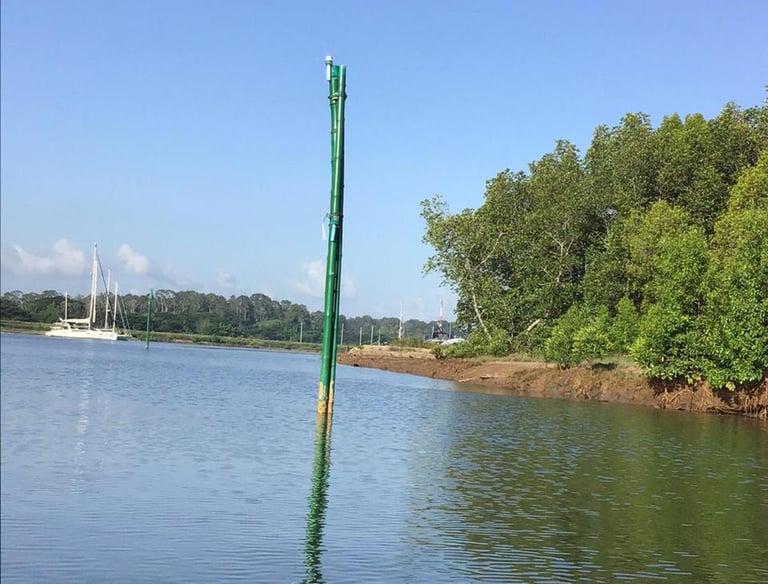 a boat on the water with a pole sticking out of it