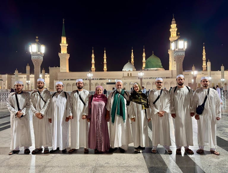 a group of muslim standing in front of Masjid An Nabi