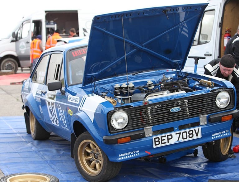 An Escort rally car improving the car set-up for a race.