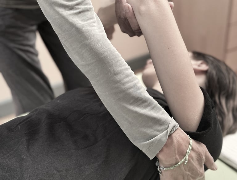 A Feldenkrais teacher moves gently with a client during a Functional Integration lesson