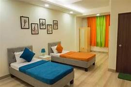 a bedroom with two beds and a door