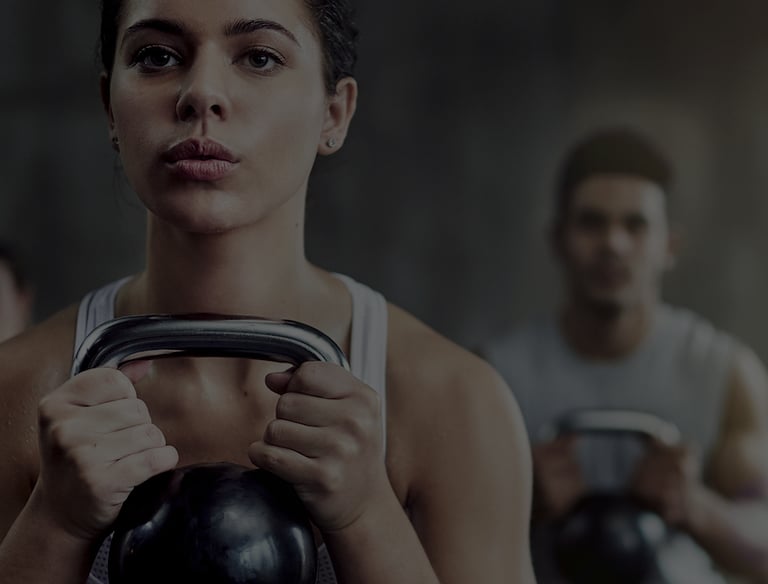 a woman squatting with a kettlebell. 