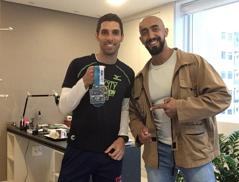 two men standing next to each other in a room