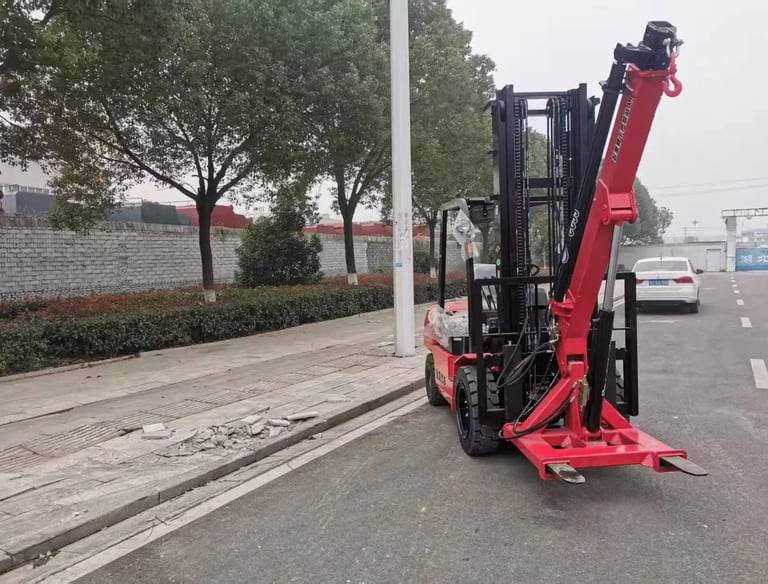 Our CC55 forklift crane attachment on a customer's red forklift. A practical forklift jib crane solution, shown outdoors.