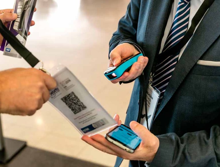 Image of a event staff scanning a QR code on a badge