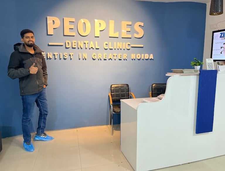 A dental patient at Peoples Dental Clinic showing a Thumbs up and recommending the dentist in greater noida