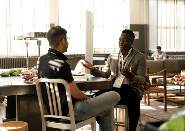 two men sitting at a table with a table with a table cloth