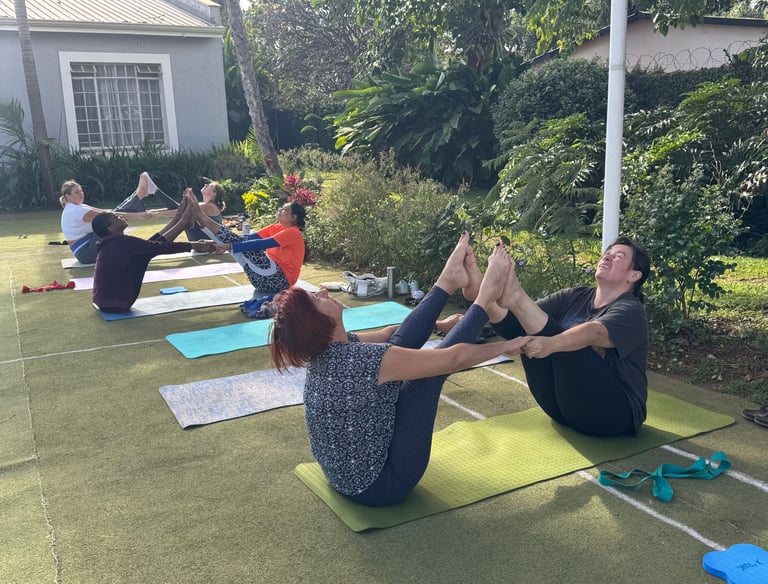Participants are practicing partner yoga for deep stretching. 