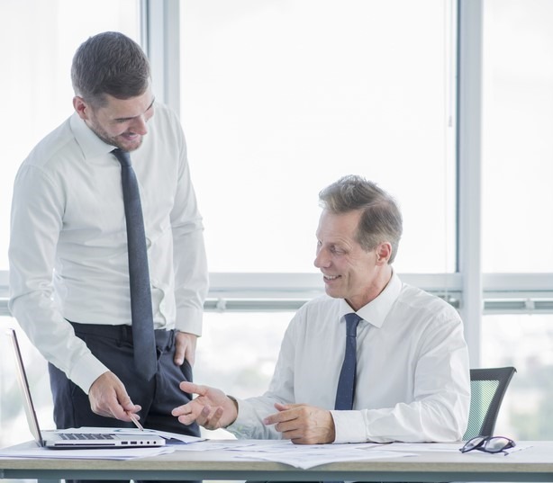 Consultant and client reviewing documents in an office Saudi Food Registration