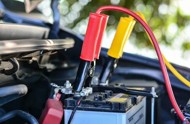 Jumper cables attached to a car battery