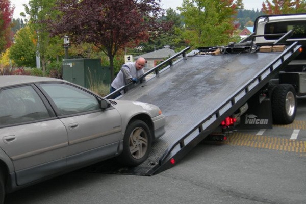 a car being towed by a tow truck