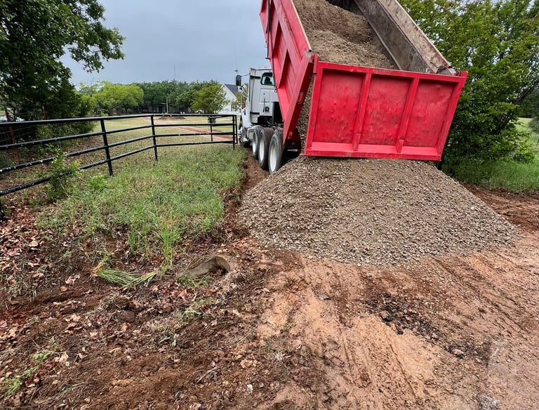 dumping gravel on dirt road