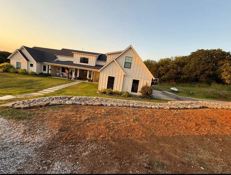 a farrm house with a stone drainage landscape