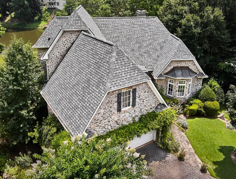 a house with a large roof and a large house with a large, stone -
