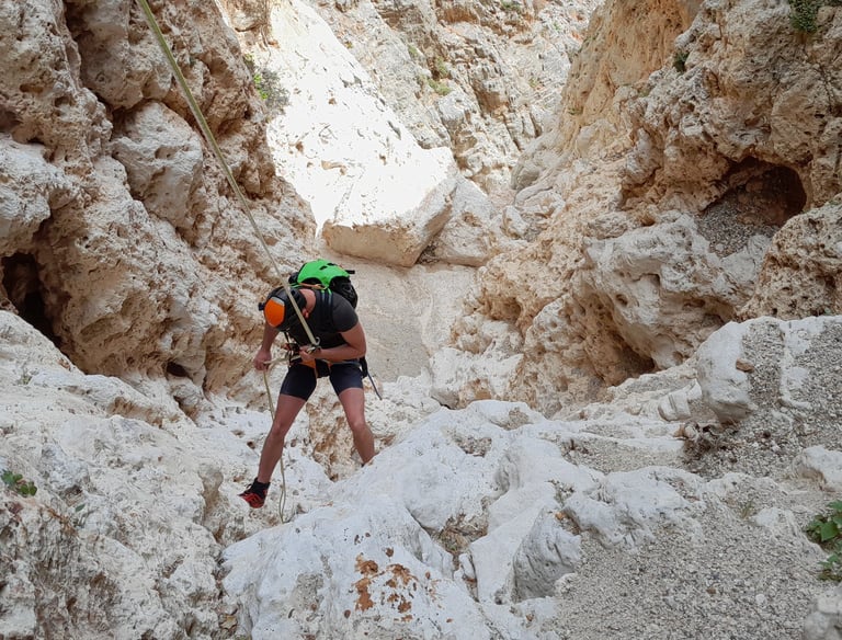 a man in a green hat and a backpacker on a mountain