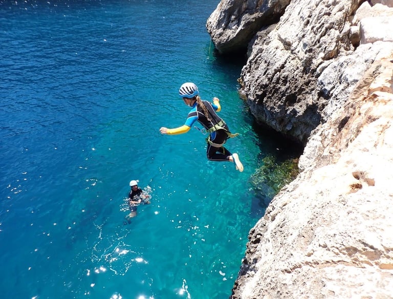 a person in a wetsuit is diving in the water