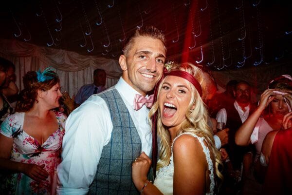 Bride and groom smiling on the dance floor at Llanerch Vineyard wedding in South Wales