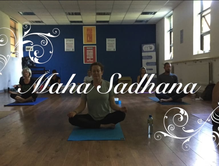 a group of people sitting meditating on yoga mats