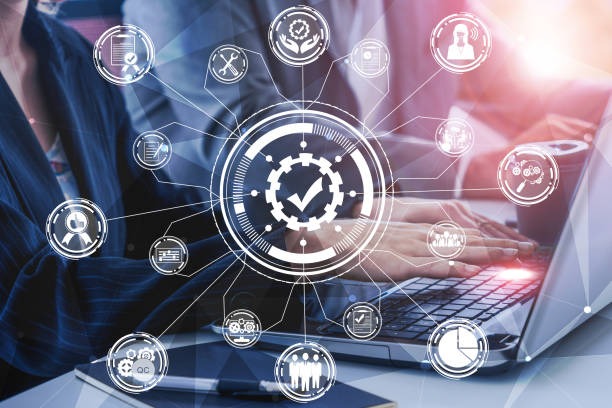 a woman in a business suit is holding a laptop and a clock on the table