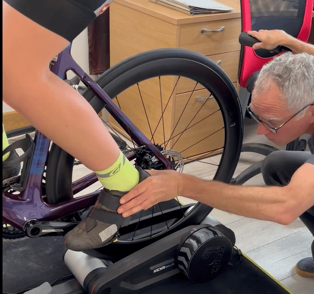 Close-up of a bike fitter checking cleat alignment