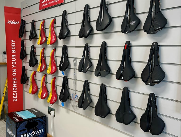 A wall full of bicycle test saddles