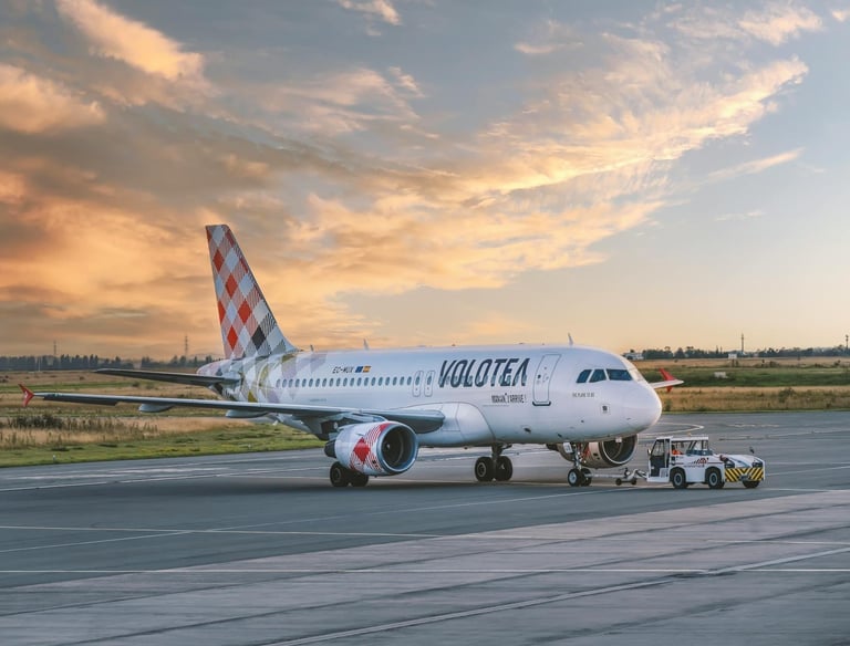 Volotea airplane on airport tarmac during sunset