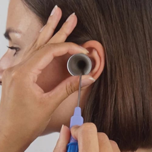 a woman having earwax removed with Microsuction
