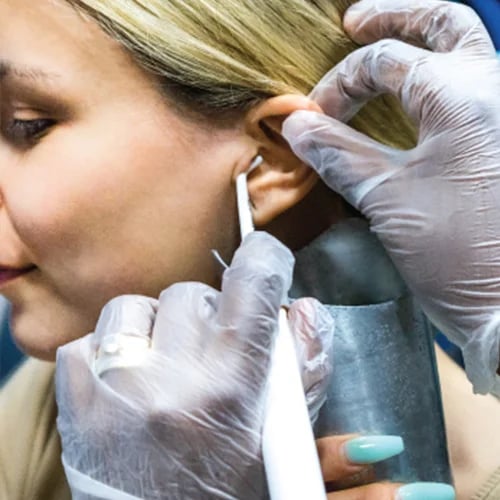 a woman having earwax removed with Water Irrigation