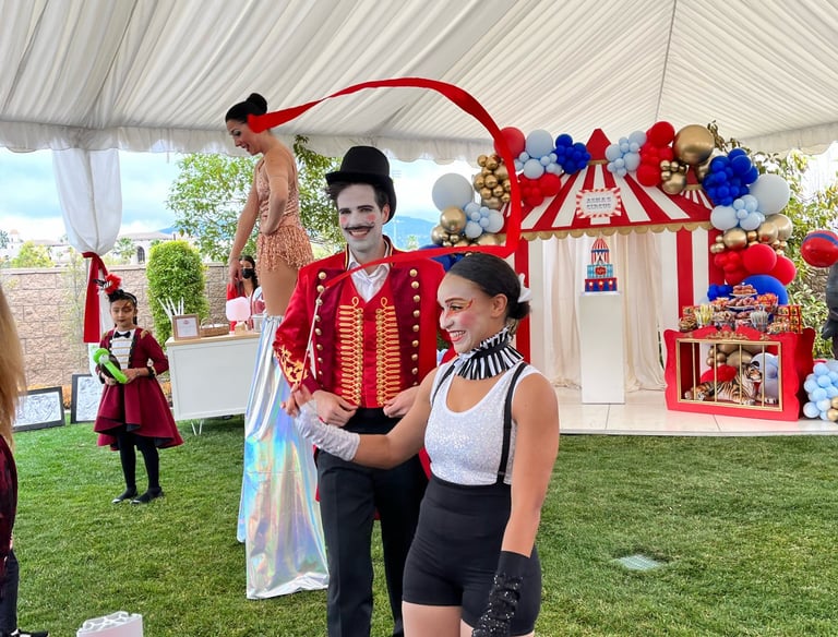 Ben HOltzmuller as Ringmaster and Tristan Avelina Cunningham ribbon twirling for Aerialogists