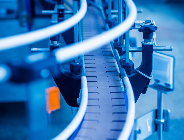 Industrial machinery and workers in a modern manufacturing plant