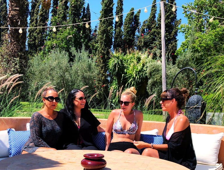 A group of women in conversation in the sun