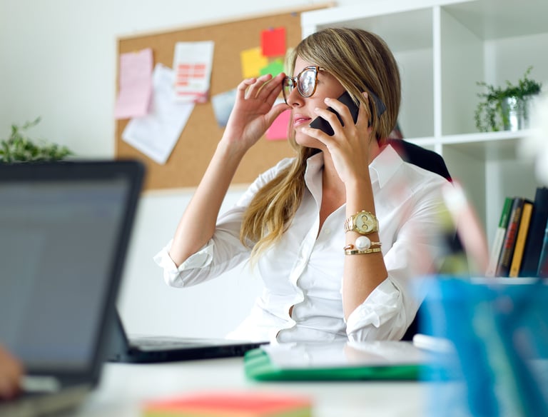 a woman in a white shirt and a laptop computer
