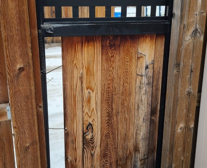 Fence gate with broken fence board under construction 