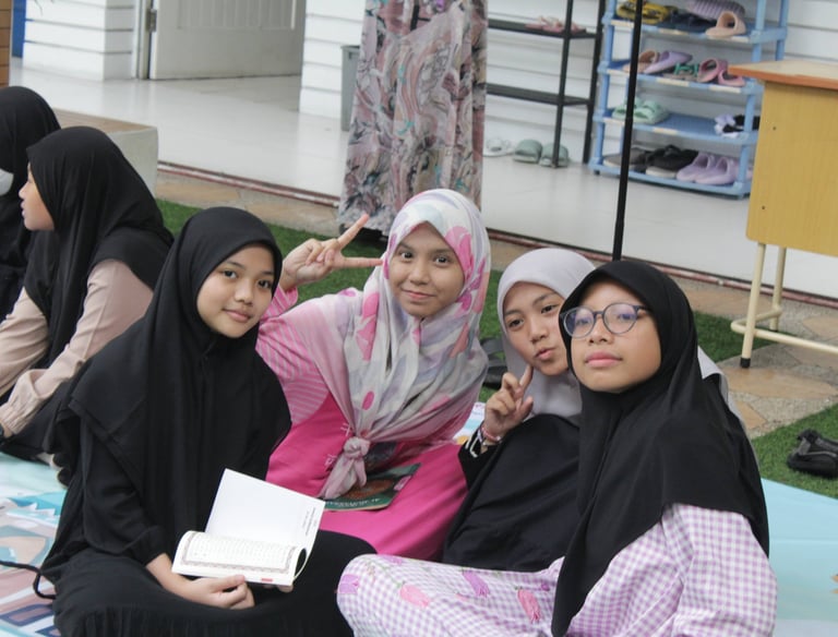 a group of women sitting on a blanket