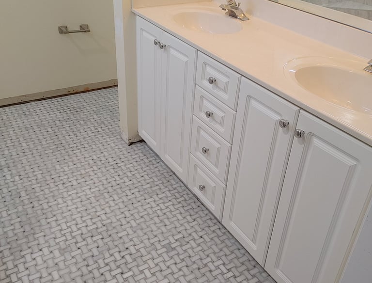 Bathroom remodel with dual-sink vanity,marble-look tile flooring and sleek fixtures—combining funcio