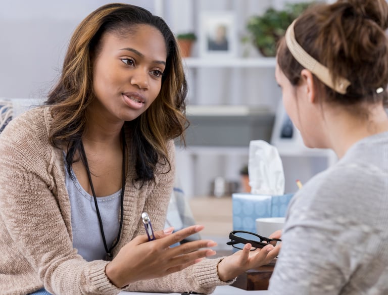 a woman in a chair talking to a woman in a chair