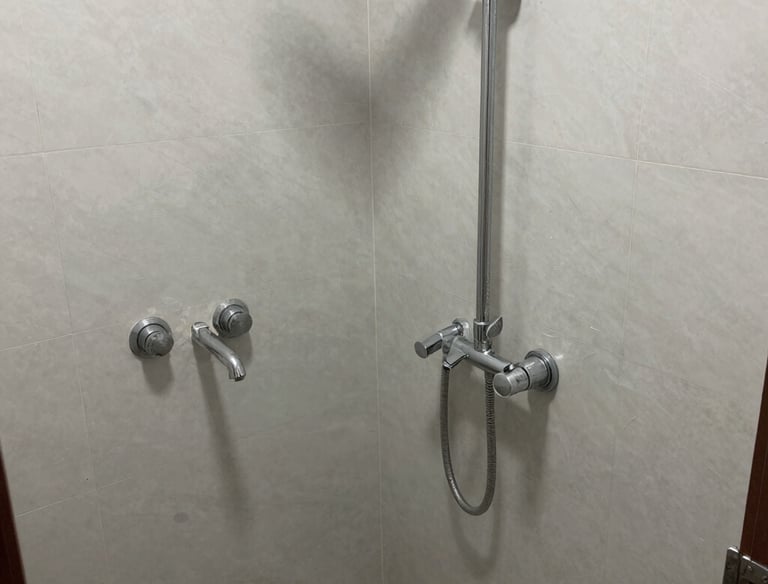 Workers assembling hotel room equipment in a factory setting with precision.