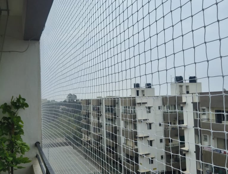 Close-up of strong, fine mesh safety netting stretched tightly over a balcony.