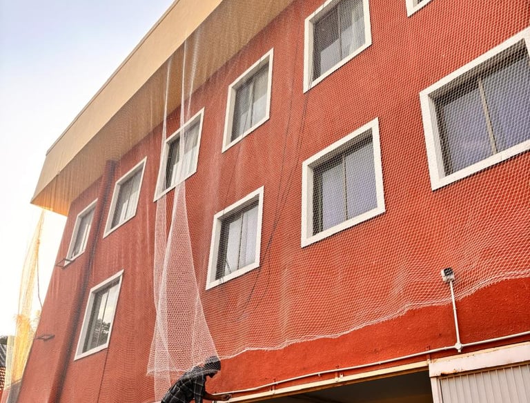 Completed balcony safety net system blending seamlessly with the building structure.