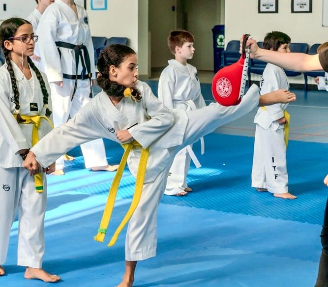 ITF Hwa Rang Yellow belt taekwondo student practicing kicking technique in Dubai