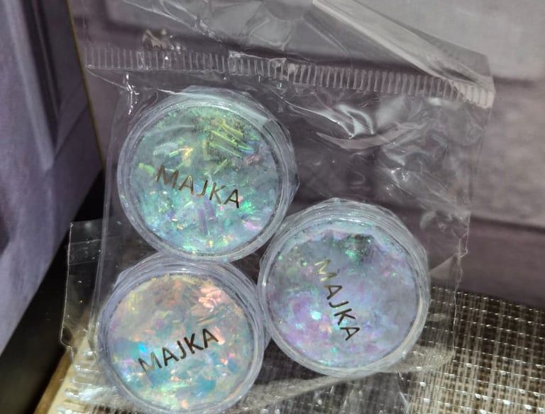 Three jars of iridescent MAJKA chunky glitter flakes for nail art in a clear plastic bag.
