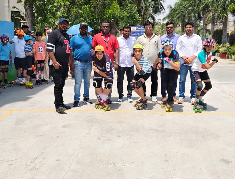Students in safety gear prepare for a roller skating competition at a public school sports event.