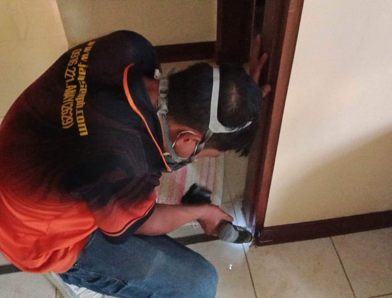 Technician from Jansen Pest Control performing termite treatment in a property in Bacolod