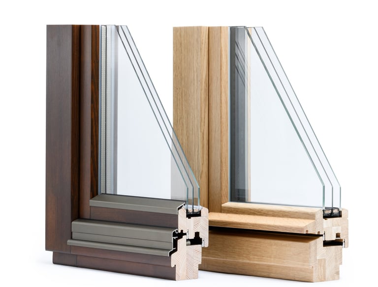 Cross-section of energy-efficient triple glazed wooden window frames in oak and dark walnut finishes.