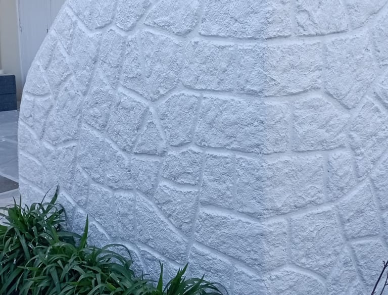 a large white rock wall with a large rock wall