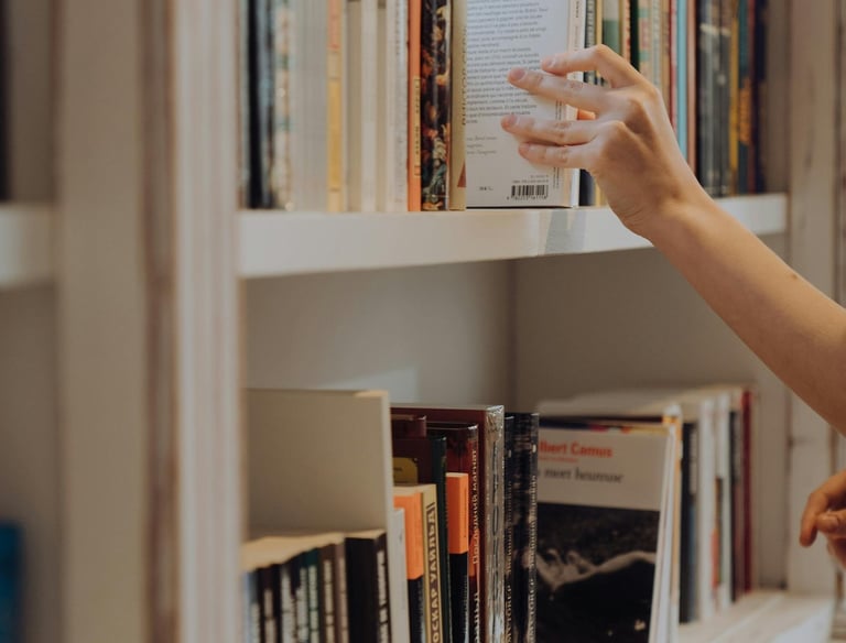 a scientist is placing at a book on a shelf
